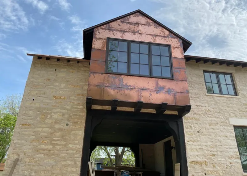 Copper metal panel facade on a stone building for Skylight Installation in Radnor